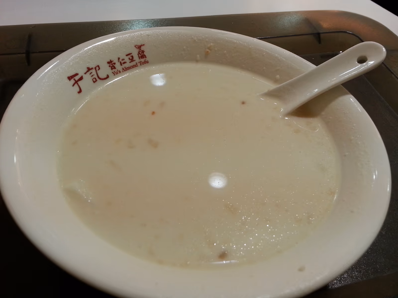 A bowl of soup with a spoon in it, taken in Taipei, Taiwan.